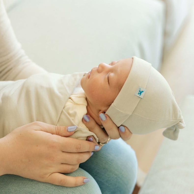 Little Unicorn Pebble swaddle used as stroller cover outdoors