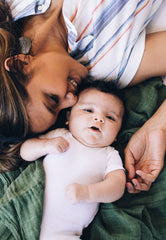 Little Unicorn Fern swaddle on baby, showcasing soft, breathable fabric for everyday use.