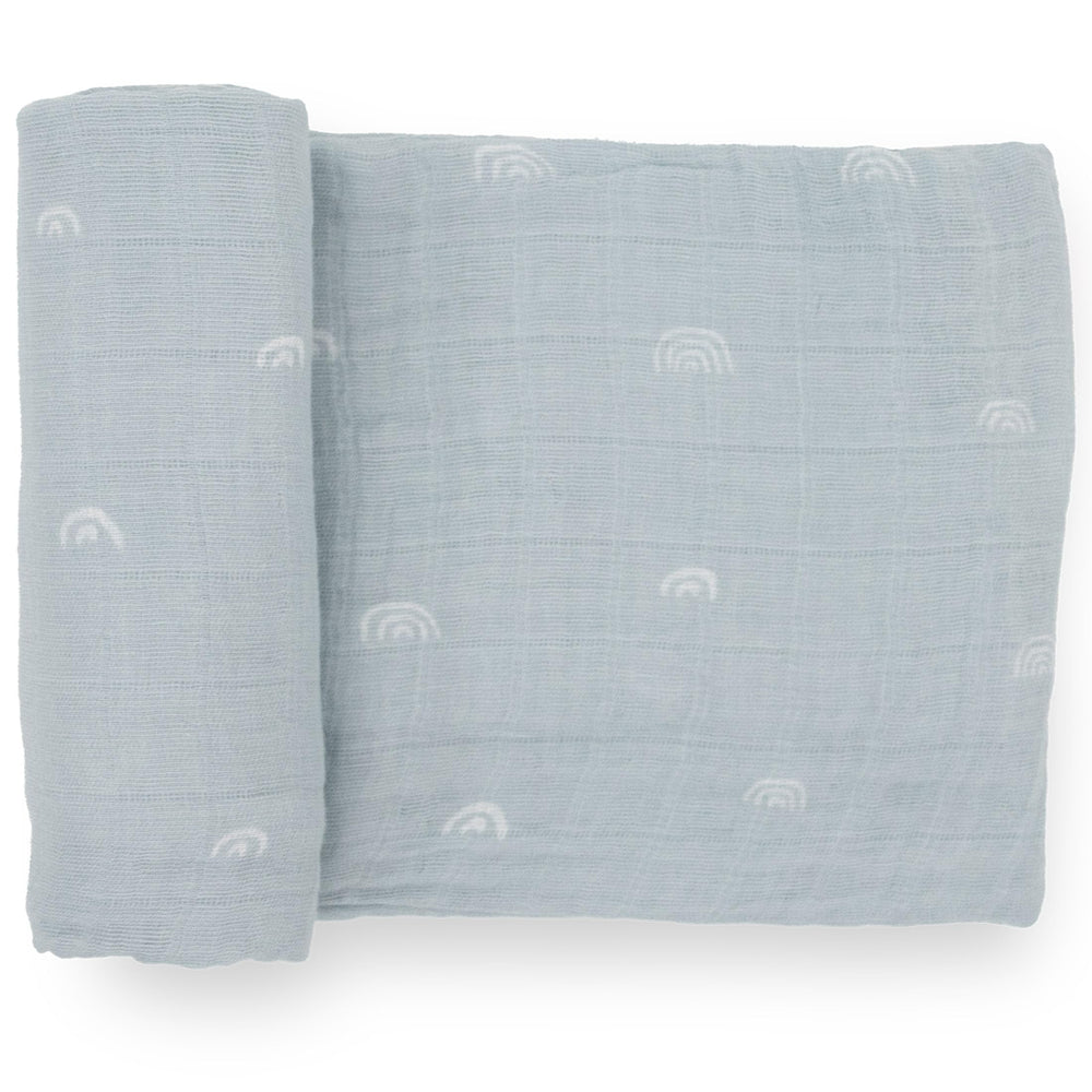 Little Unicorn swaddle flatlay with breathable cotton muslin and blue rainbow design for comfort
