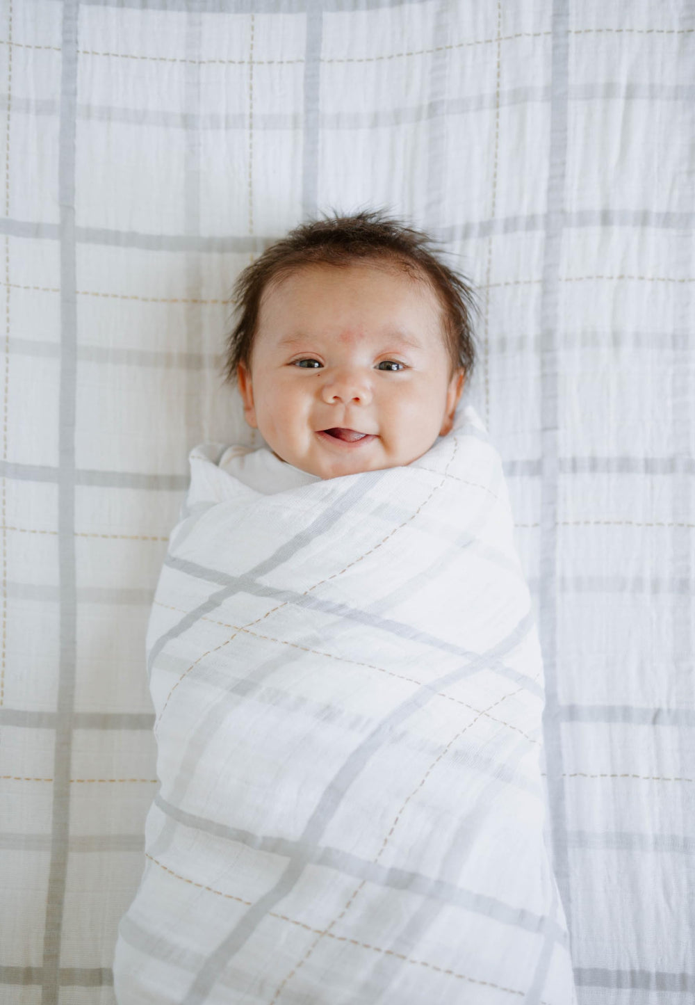 Little Unicorn swaddle grey plaid baby blanket unrolled for display of breathable fabric