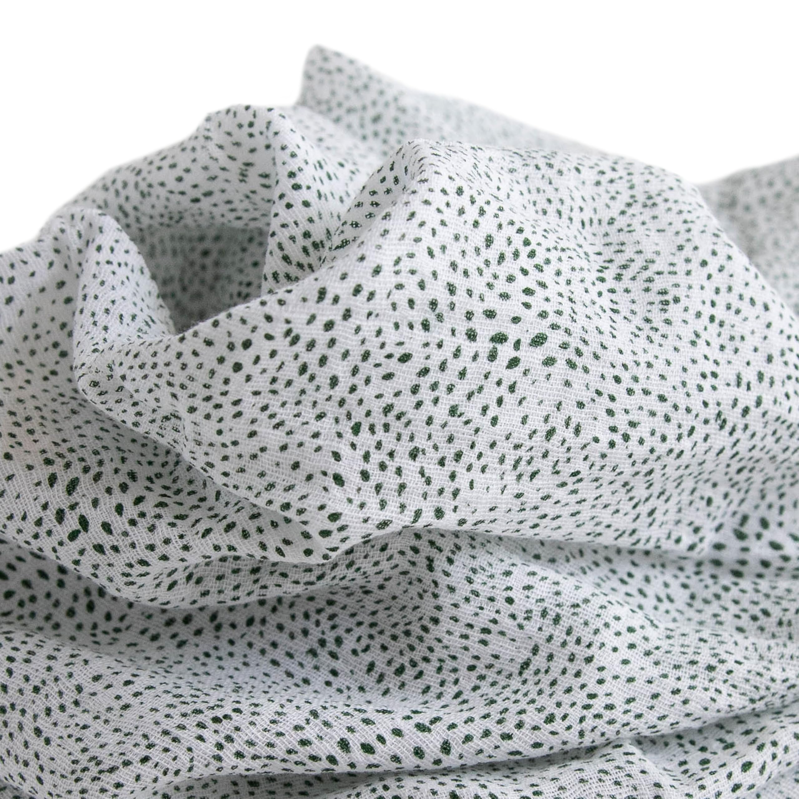 Little Unicorn swaddle close-up shows soft muslin fabric for gentle hugs.