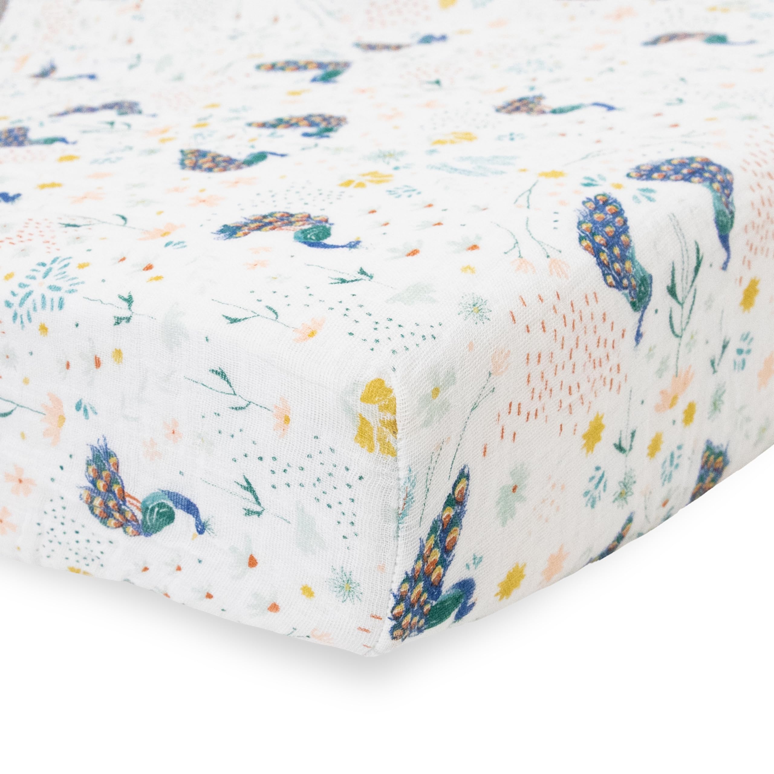 Little Unicorn premium crib sheet Peacock on mattress showcases breathable muslin for year-round comfort.