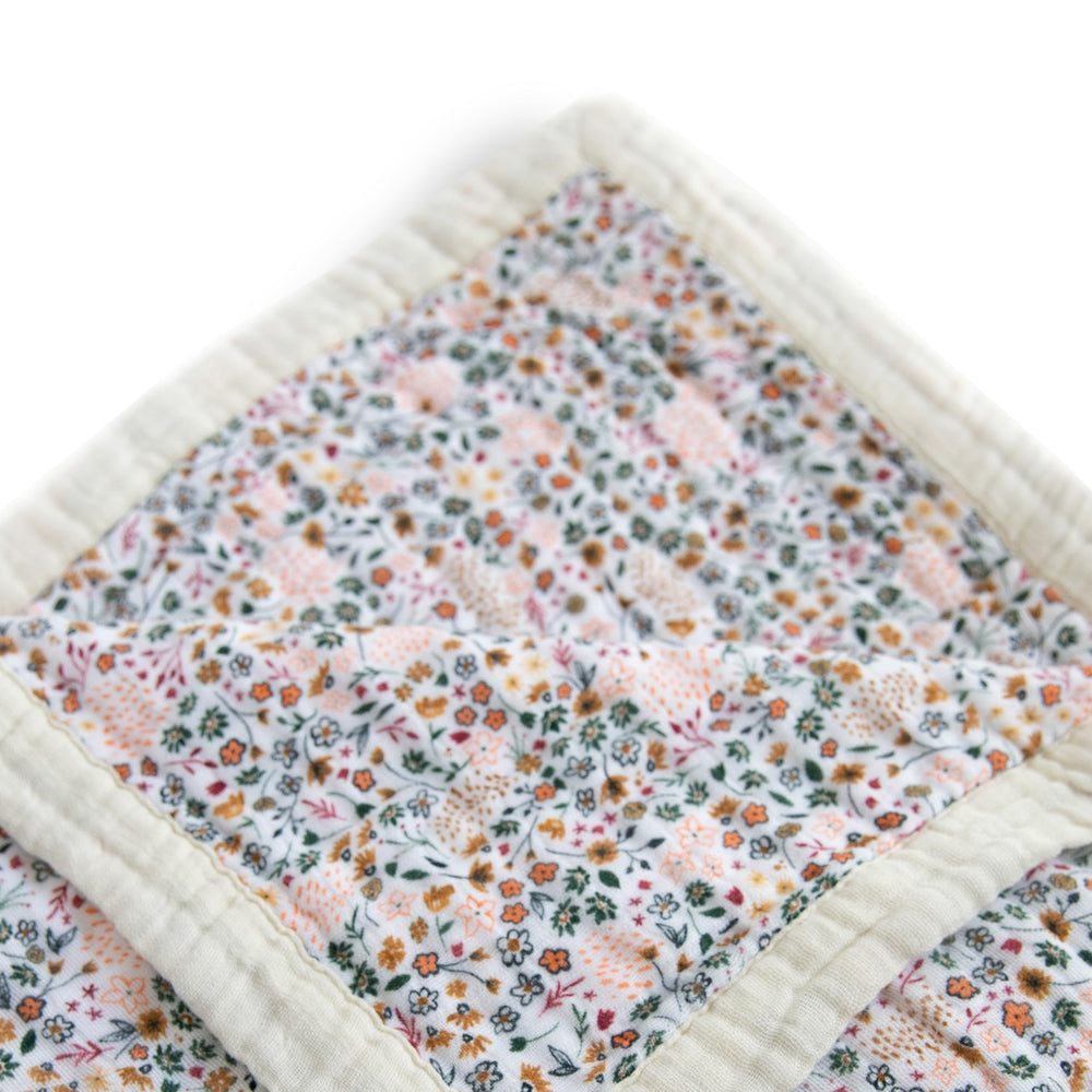 Little Unicorn Premium Quilted Throw soft muslin detail highlights breathable warmth for naps and play.