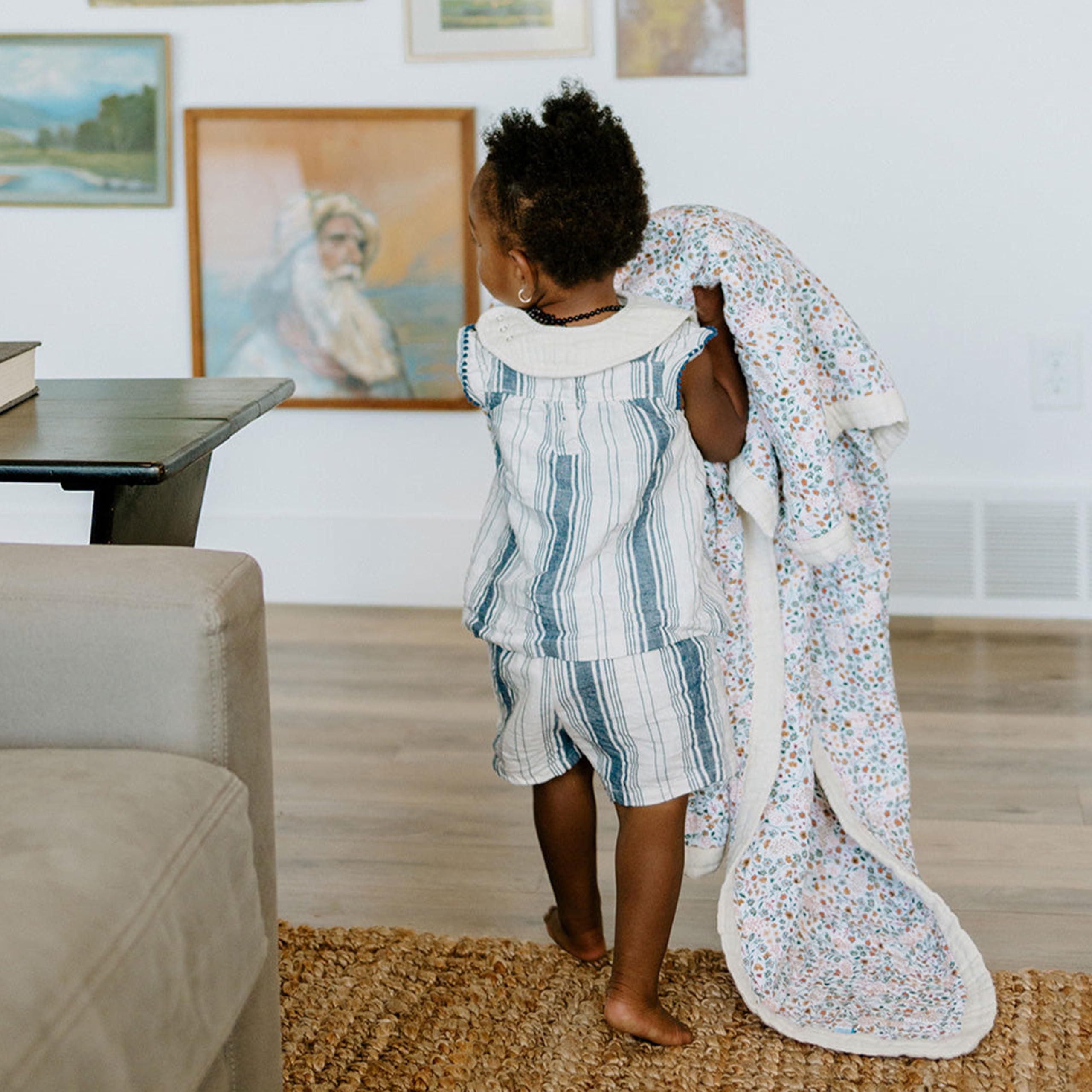 Little Unicorn Premium Quilted Throw demonstrates machine washable care for daily use.