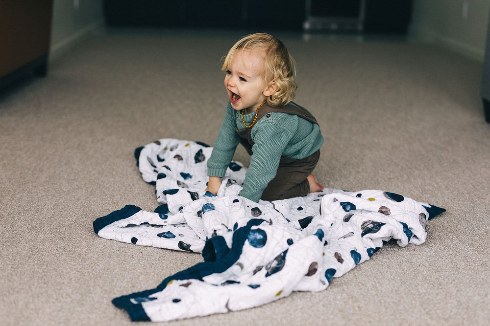 Little Unicorn Premium Quilted Throw features durable stitching for daily use.