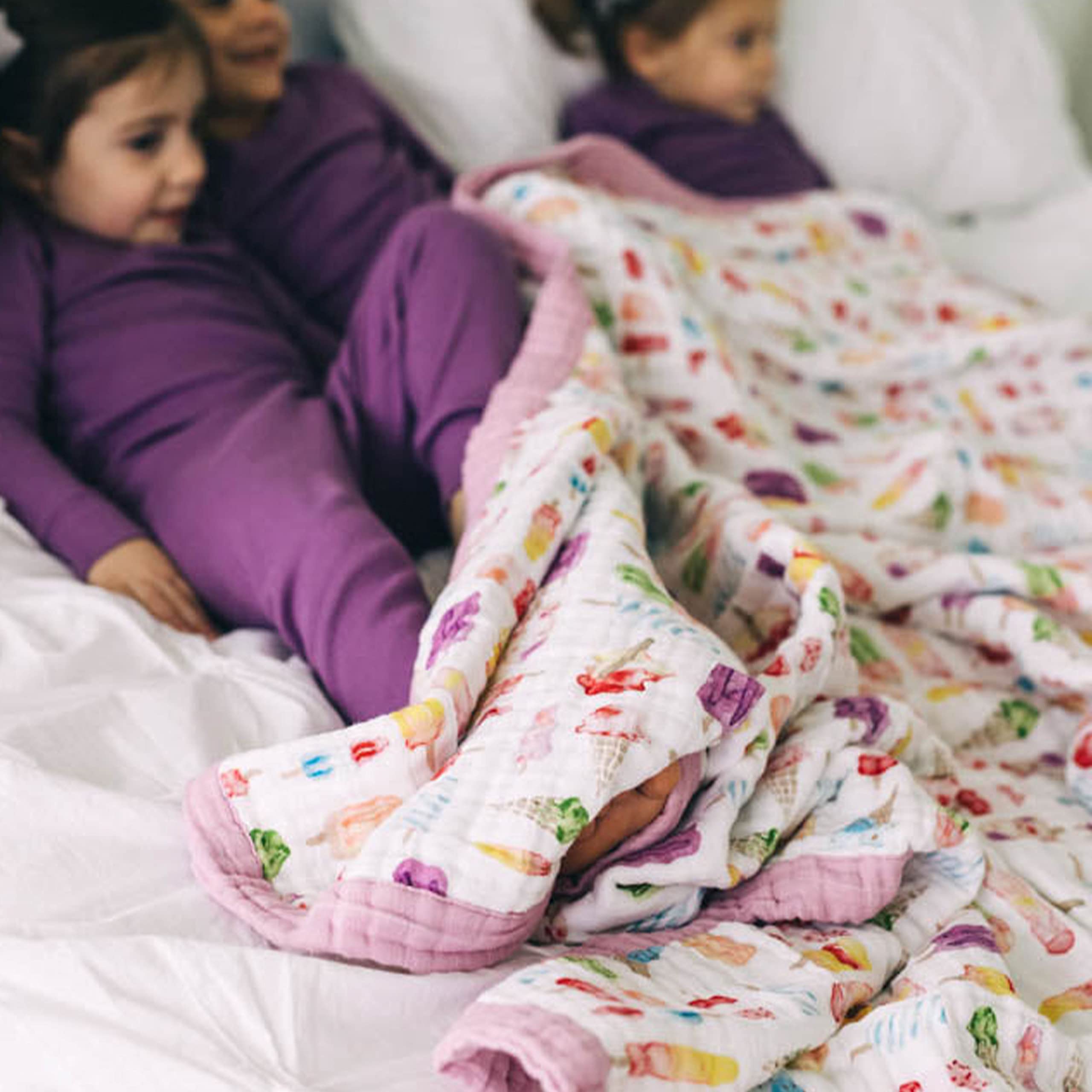 Little Unicorn Premium Quilted Throw in a cozy nursery setting for family time