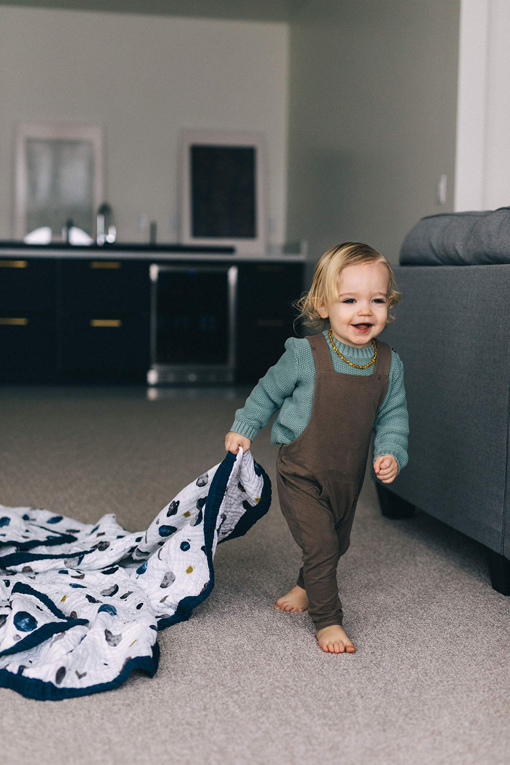 Little Unicorn Premium Quilted Throw reversible design adds nursery versatility.