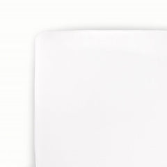 Little Unicorn stretch knit crib sheet in white, flat lay, highlighting softness and quality