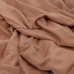 Little Unicorn pressed petals swaddle blanket on baby demonstrates lightweight comfort during calm moments