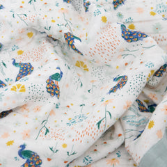 Little Unicorn peacock-pattern quilt adds color while supporting on-the-go routines.