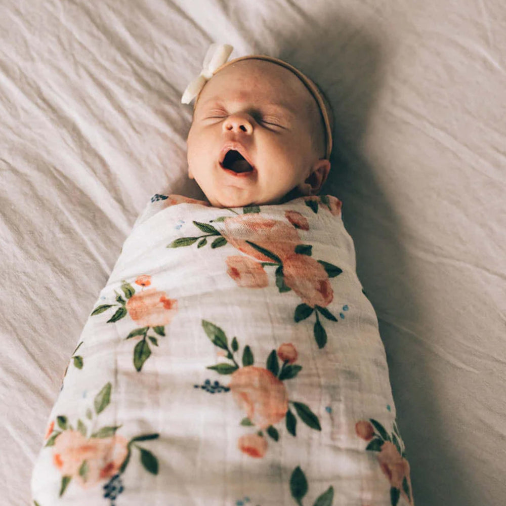 Little Unicorn soft-fold blanket with rose design provides a compact, everyday wrap option