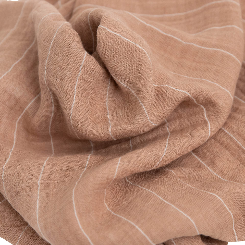 Little Unicorn Mauve Stripe swaddle fabric detail highlights breathable cotton.