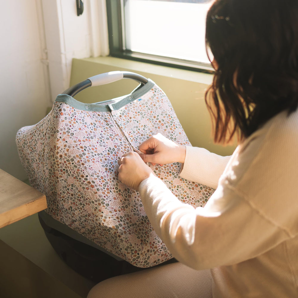Little Unicorn universal-fit canopy protects privacy on most infant seats.