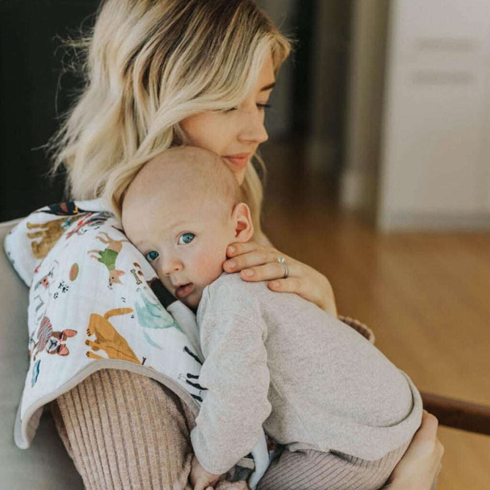 Little Unicorn Woof burp cloth on shoulder during burping for extra coverage.
