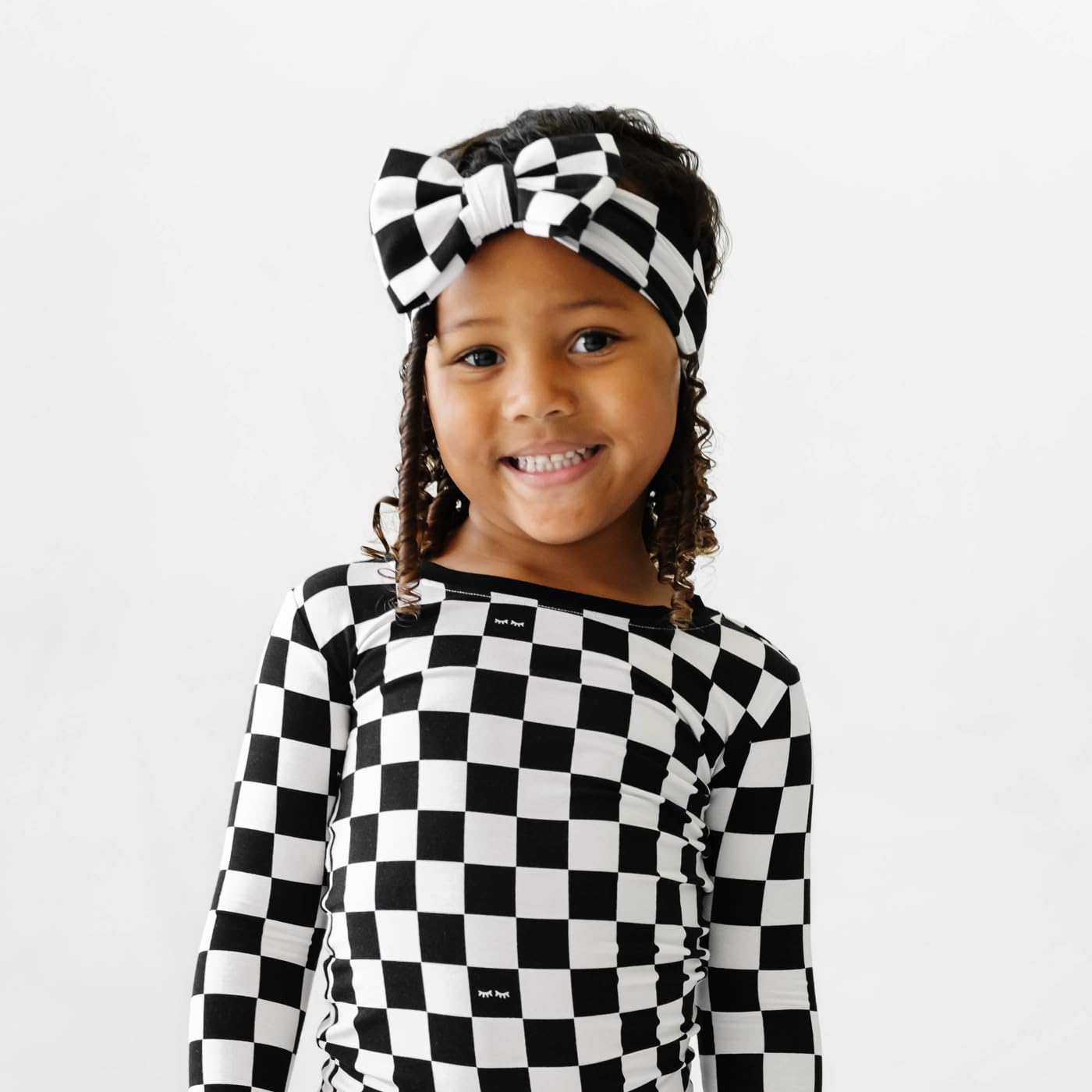 Little Sleepies Luxe Bow Headband Checks pairs with swaddles for coordinated baby outfits