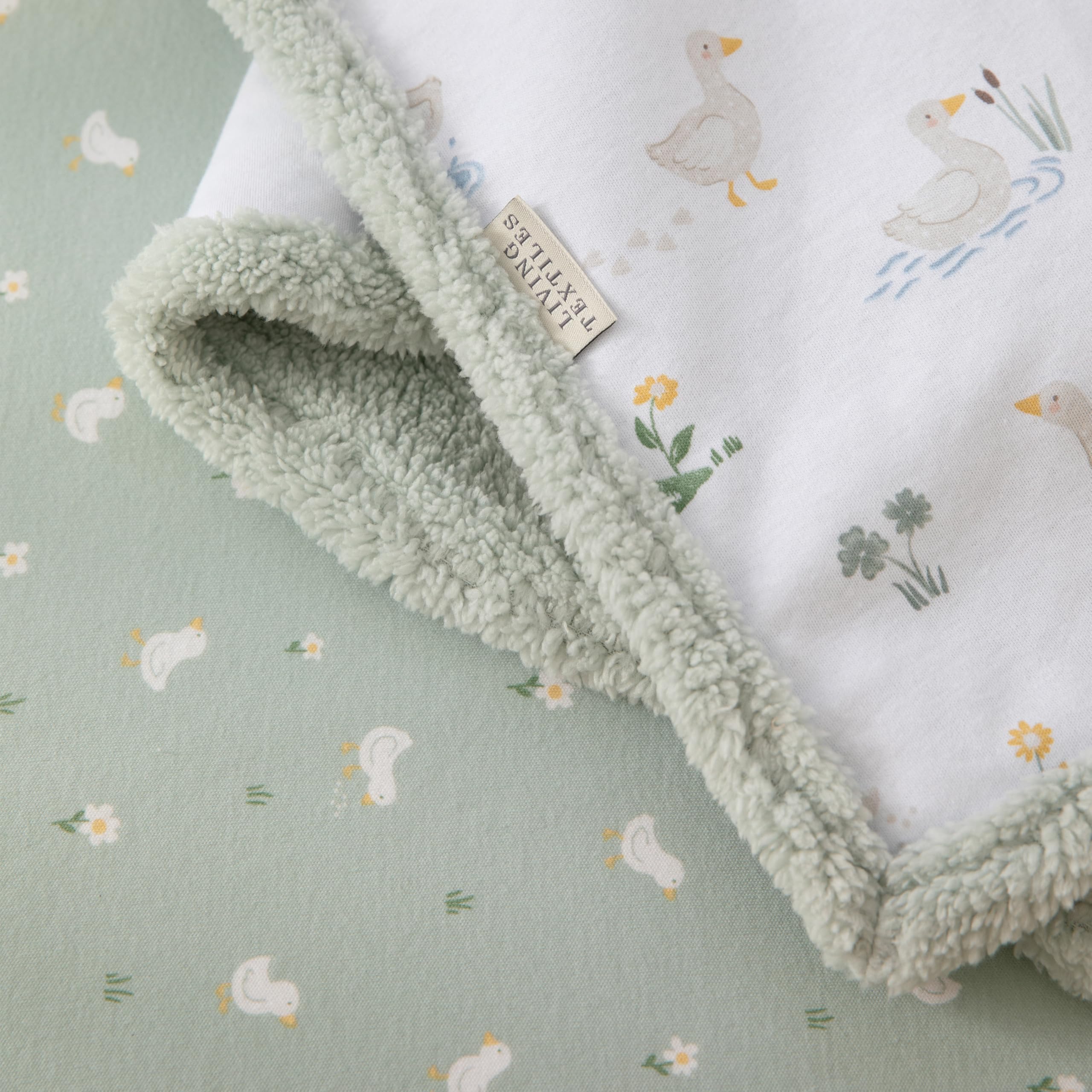 Living Textiles Goosey Goosey sherpa blanket back view shows plush sherpa warmth for snuggly naps