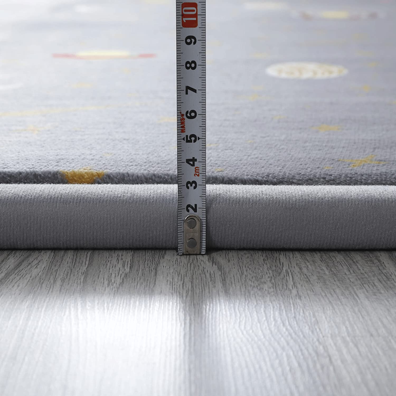 Loartee astral gray nursery rug offers a gentle surface for crawling and play.