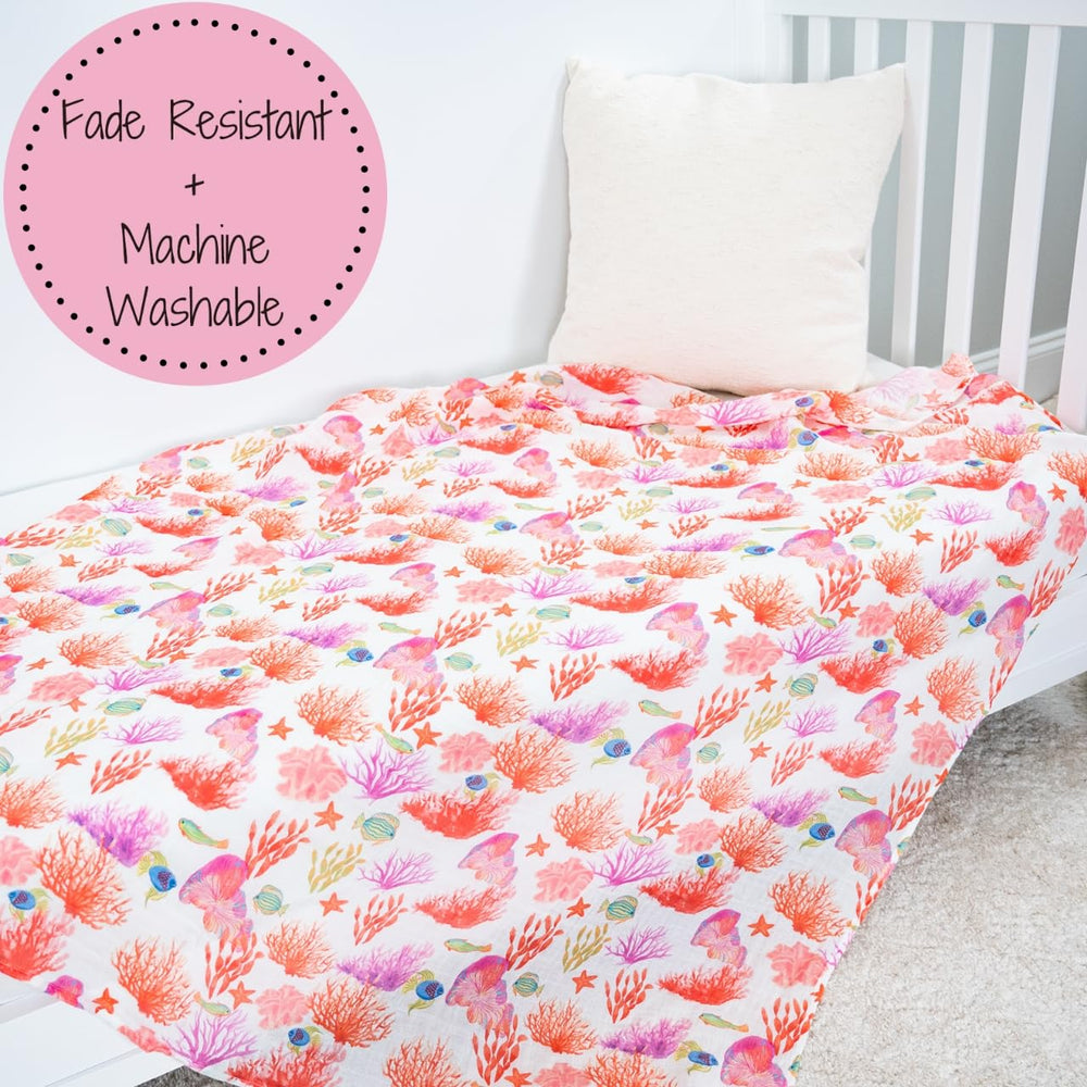 LollyBanks baby wrapping snugly with coral blanket in nursery