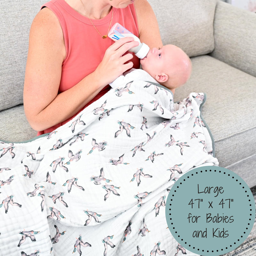 LollyBanks duck-print blanket folded in bag illustrates travel-friendly nursery essential.