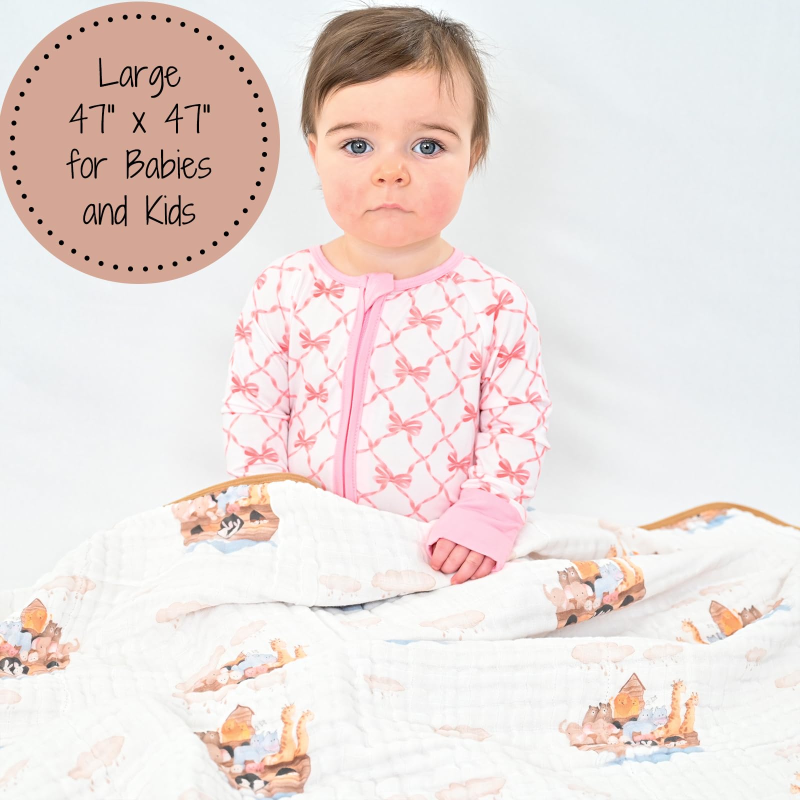 LollyBanks baby cuddling with the muslin blanket for warm, snug comfort.