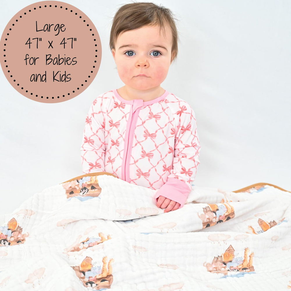 LollyBanks baby cuddling with the muslin blanket for warm, snug comfort.