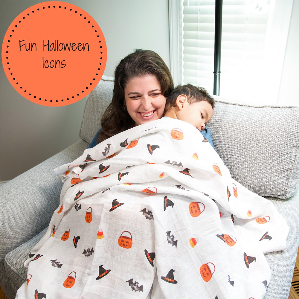 LollyBanks nursery decor swaddle blanket on crib.