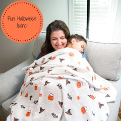 LollyBanks nursery decor swaddle blanket on crib.