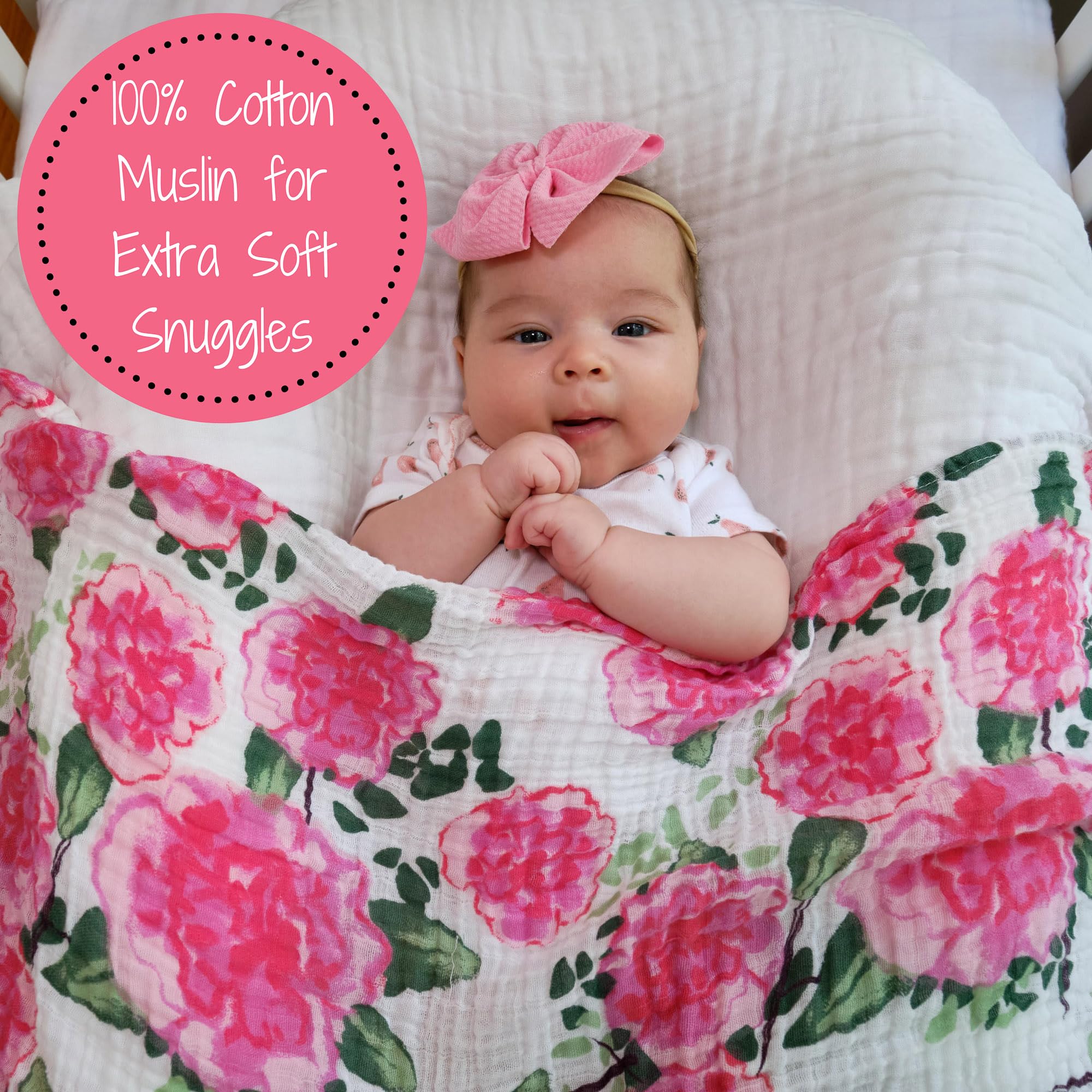 LollyBanks Peony Print swaddle in baby's arms, soft cotton muslin provides secure comfort.
