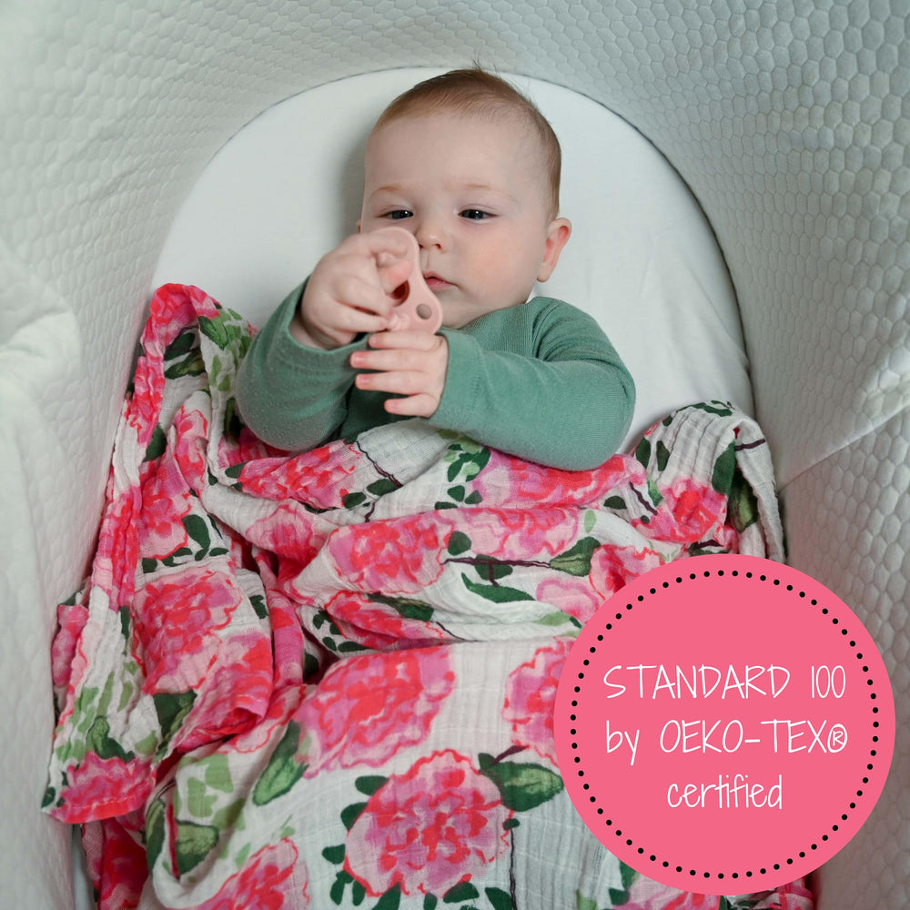 Peony print blanket hanging in nursery, adds decorative soft ambience.