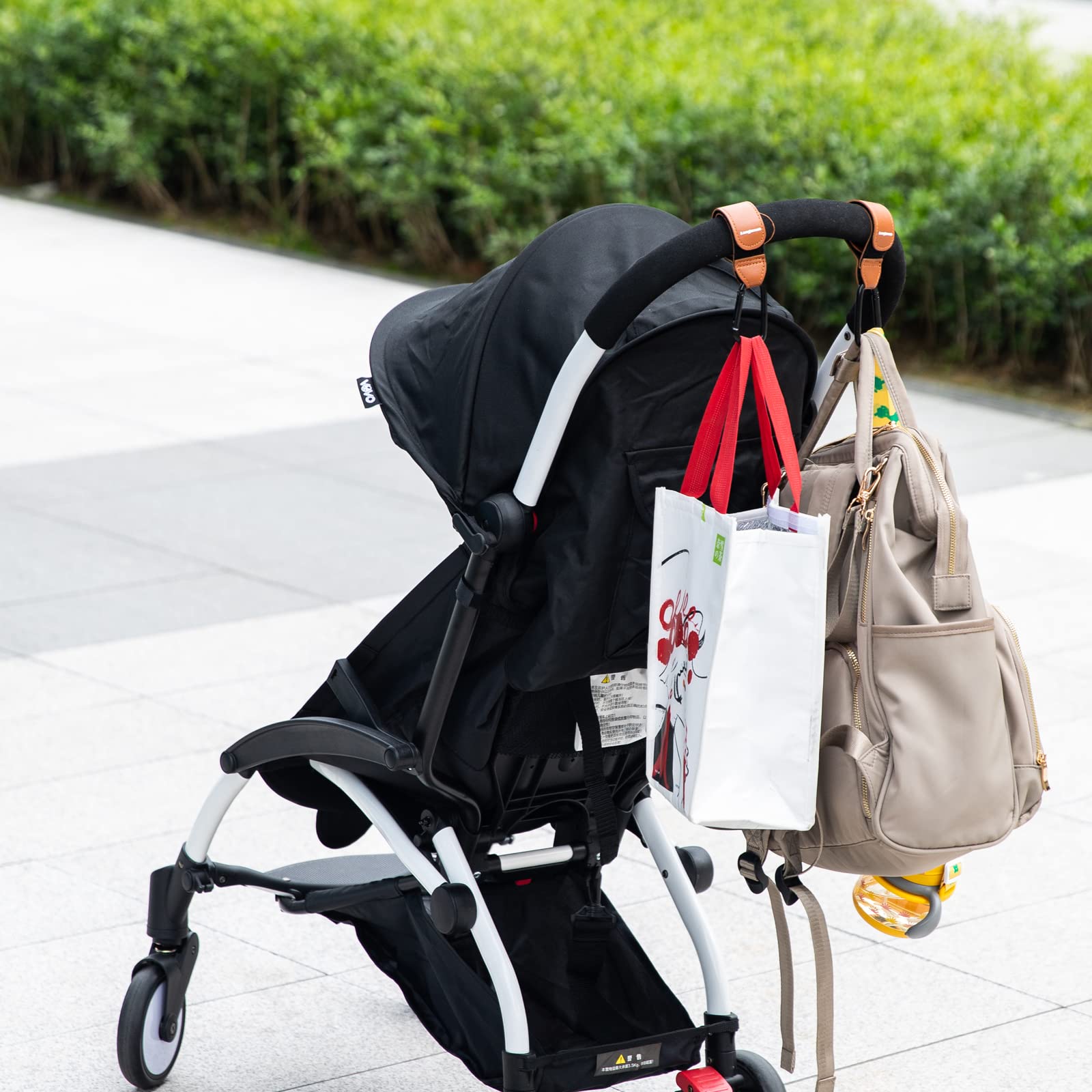 Longomat hanging diaper bag hook in use on a stroller.