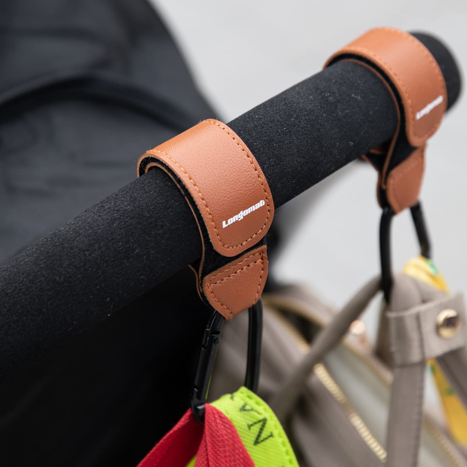 Longomat leather and aluminum hook construction for durable daily use.