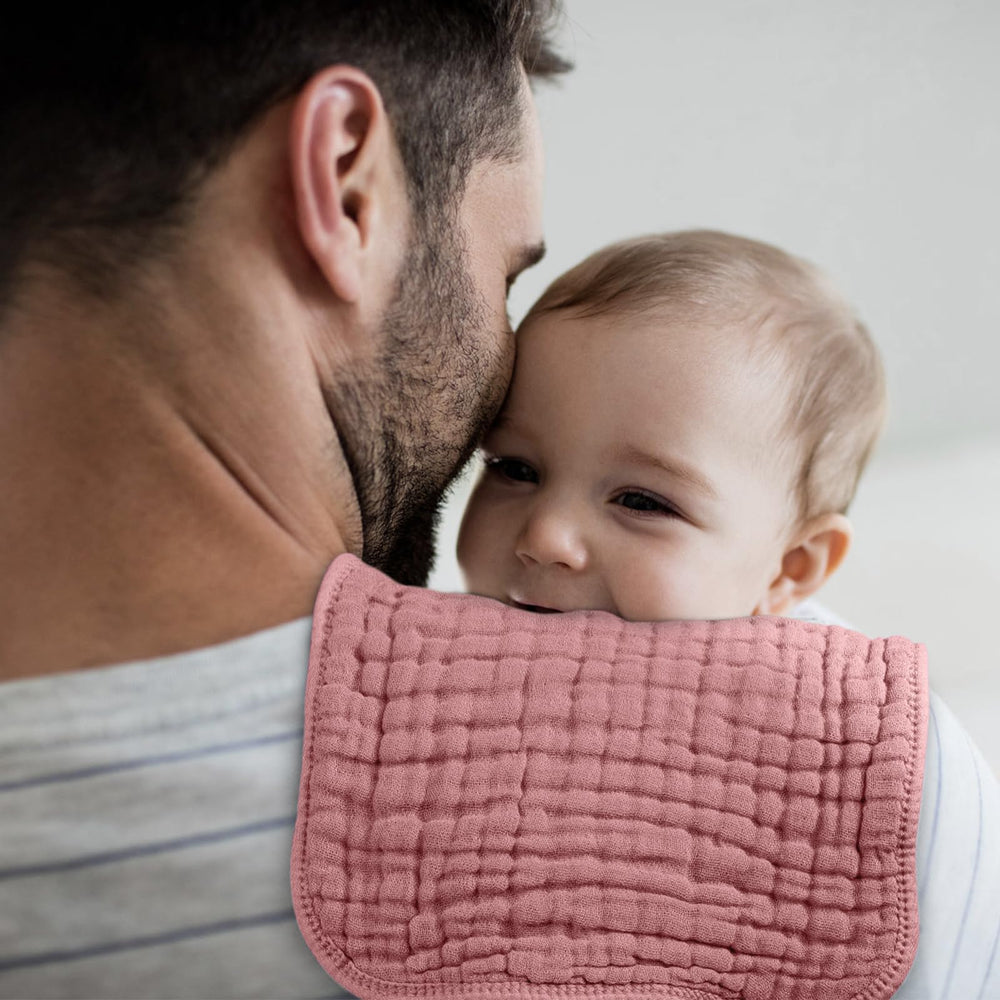 Looxii baby burp cloth catches spit-up and drool during feeds.