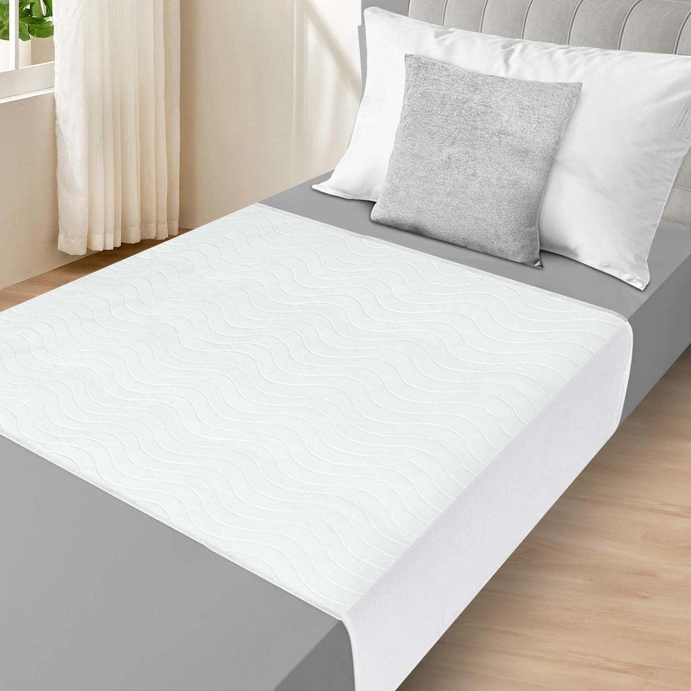 LotuFlor bed pad with tuckable wings keeps protection in place overnight.