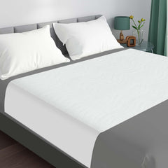 LotuFlor bed pad with tuckable wings for secure overnight protection