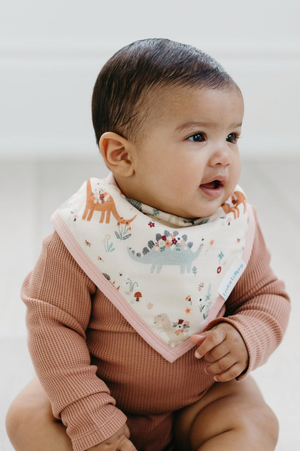 Loulou Lollipop bandana bib set baby wearing with a smile.