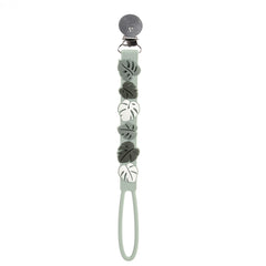 Loulou Lollipop beadless silicone pacifier clip Monstera green keeps the pacifier secure.