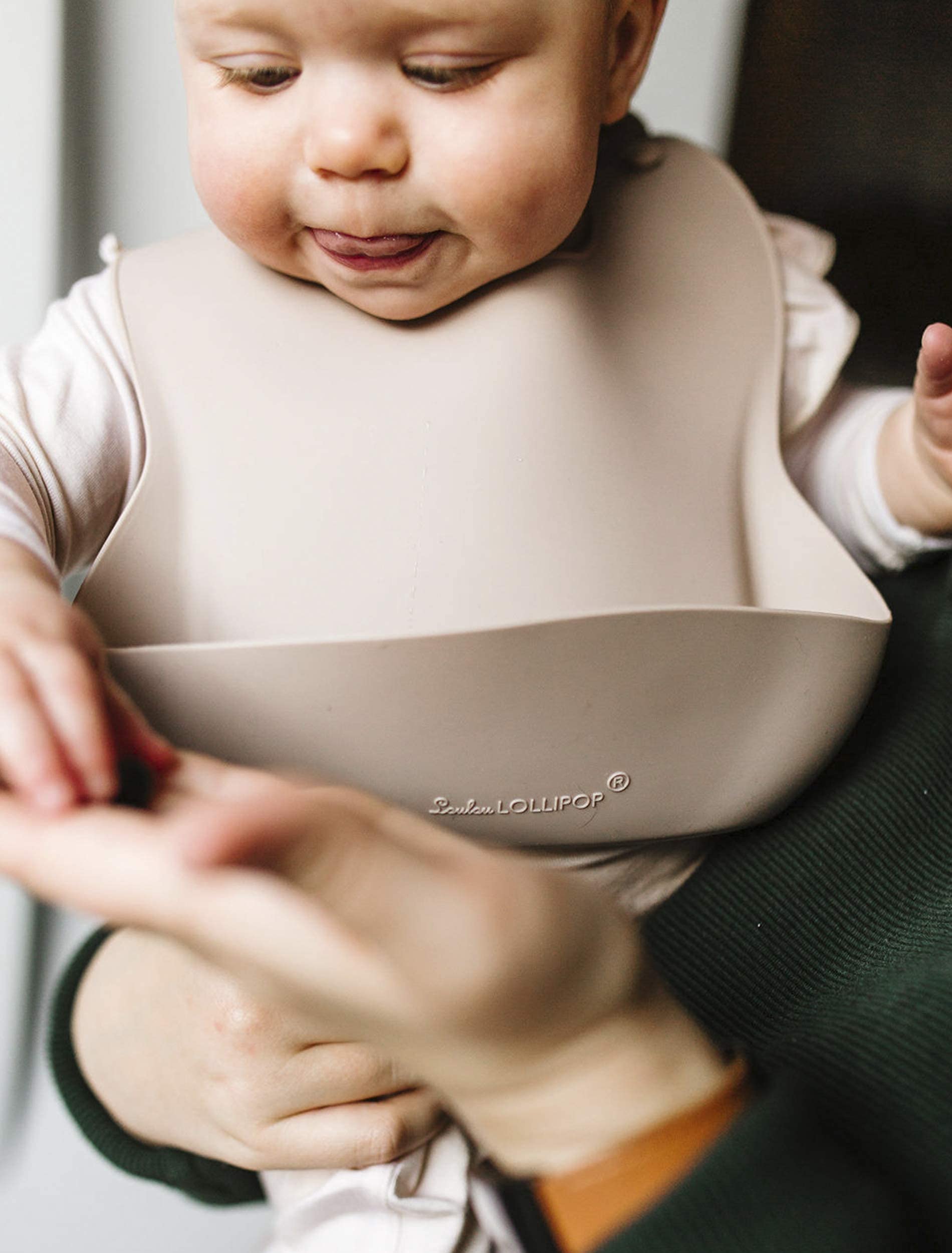 Loulou Lollipop modern sand color bib complements baby gear.