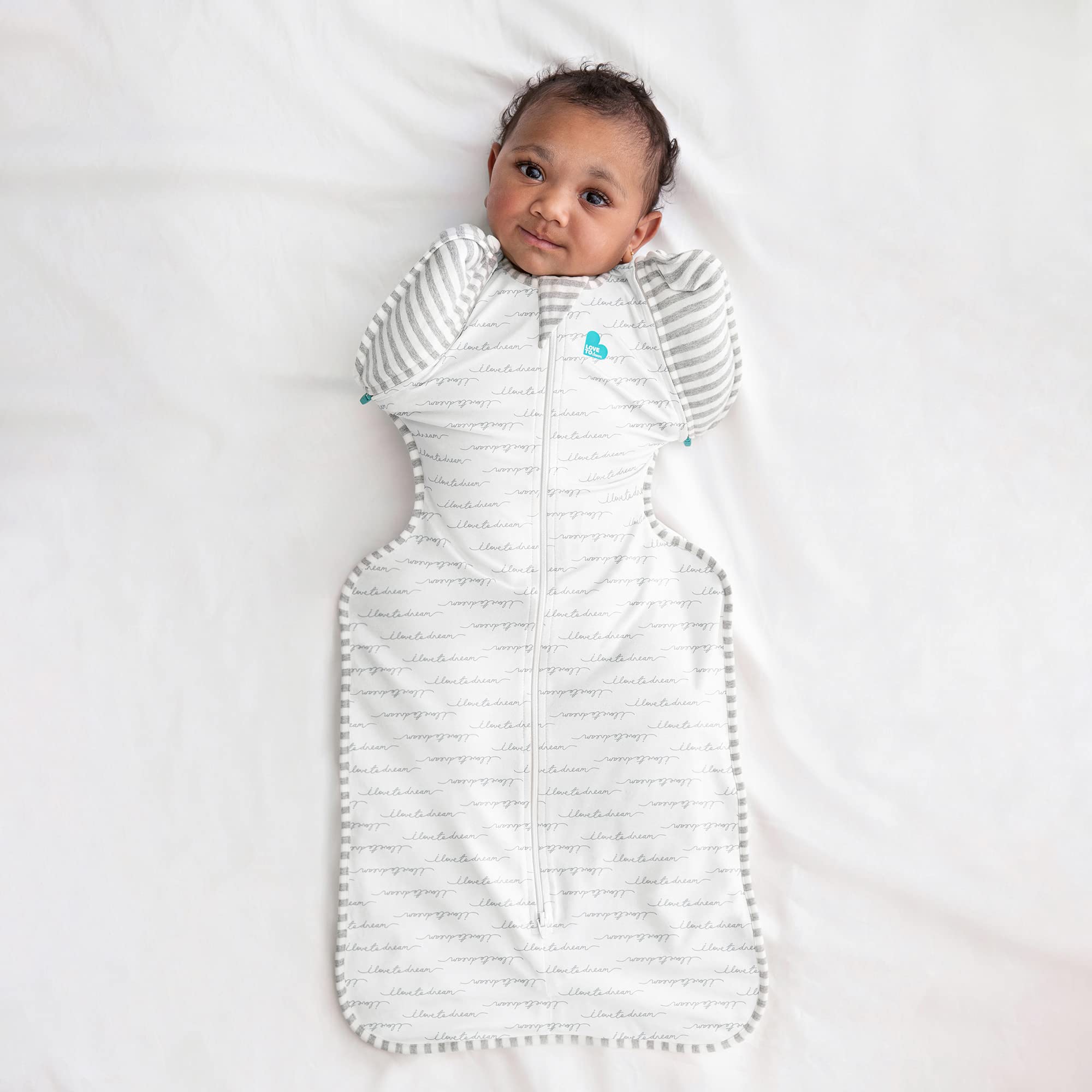 Love to Dream white swaddle complements nursery decor and soft fabric.