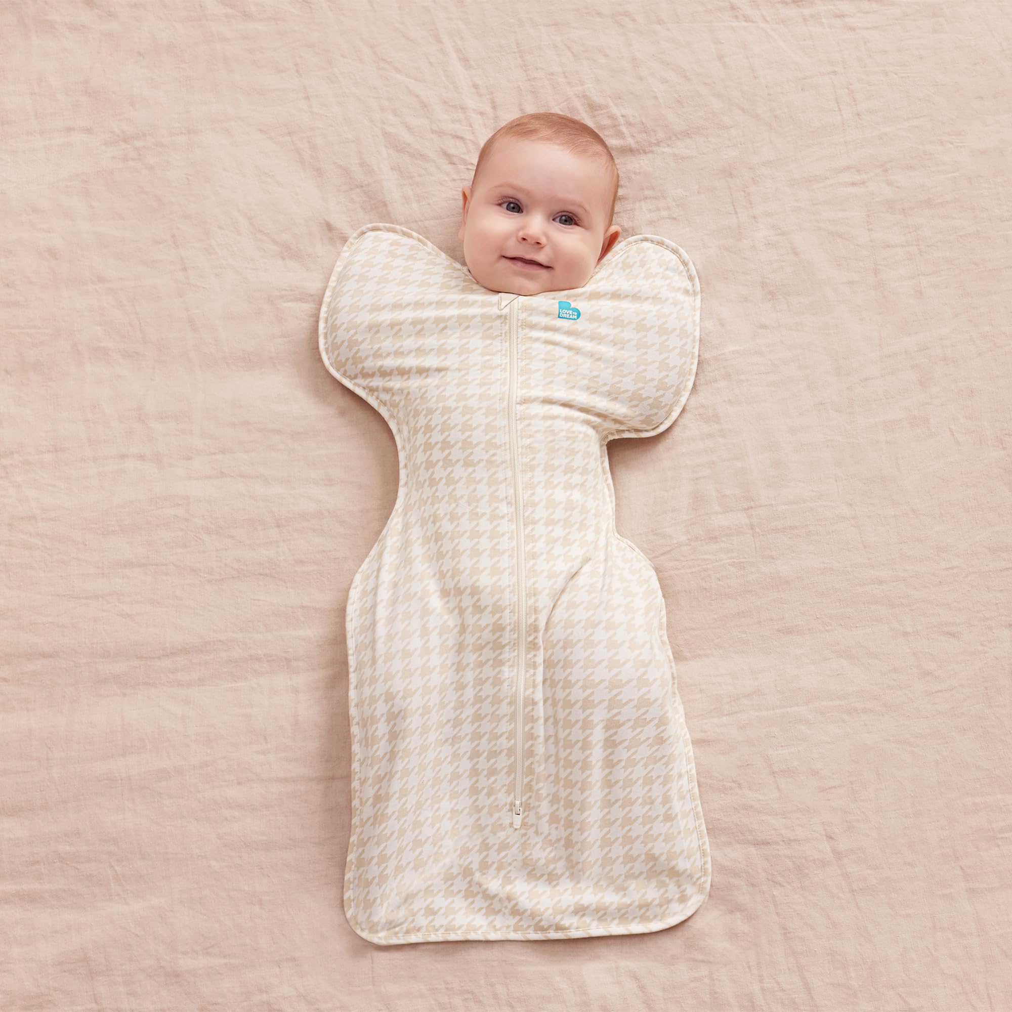 Love to Dream Swaddle Up 1.0 tog in tan houndstooth for breathable warmth.