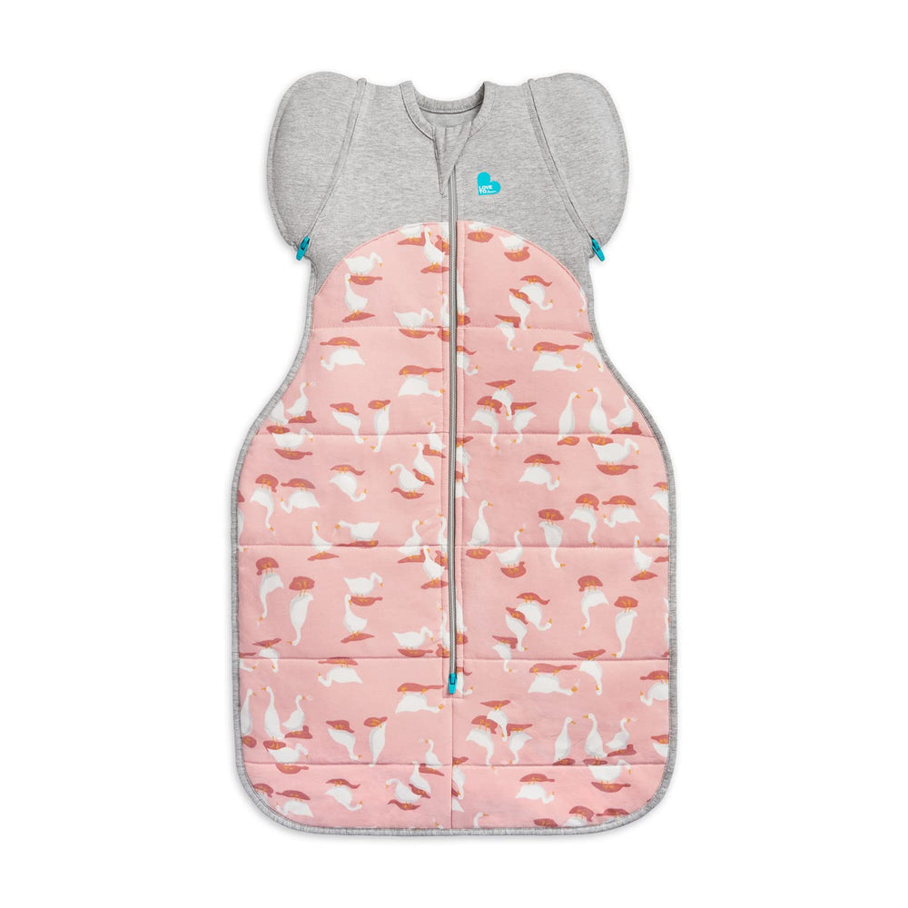 Baby sleeping peacefully with arms transitioning in the Love to Dream bag
