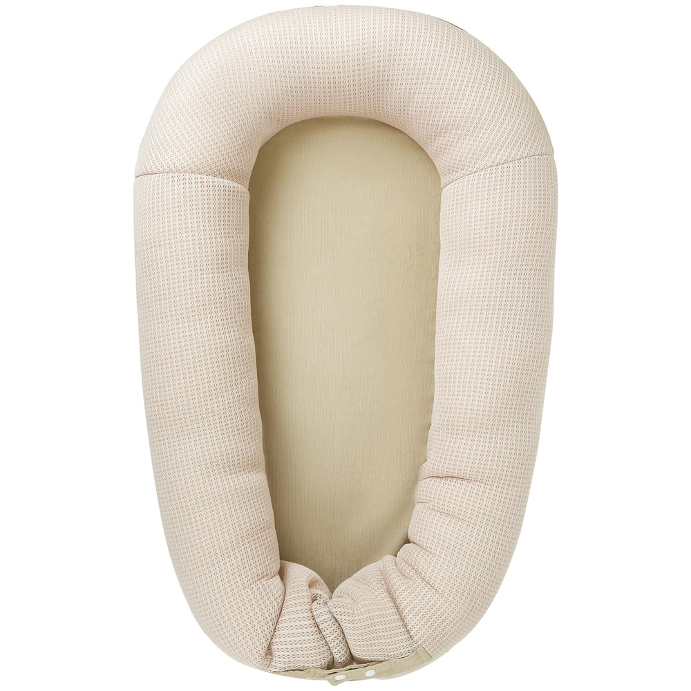 LOVE MAGE baby lounger in soft cotton for gentle comfort during supervised play.