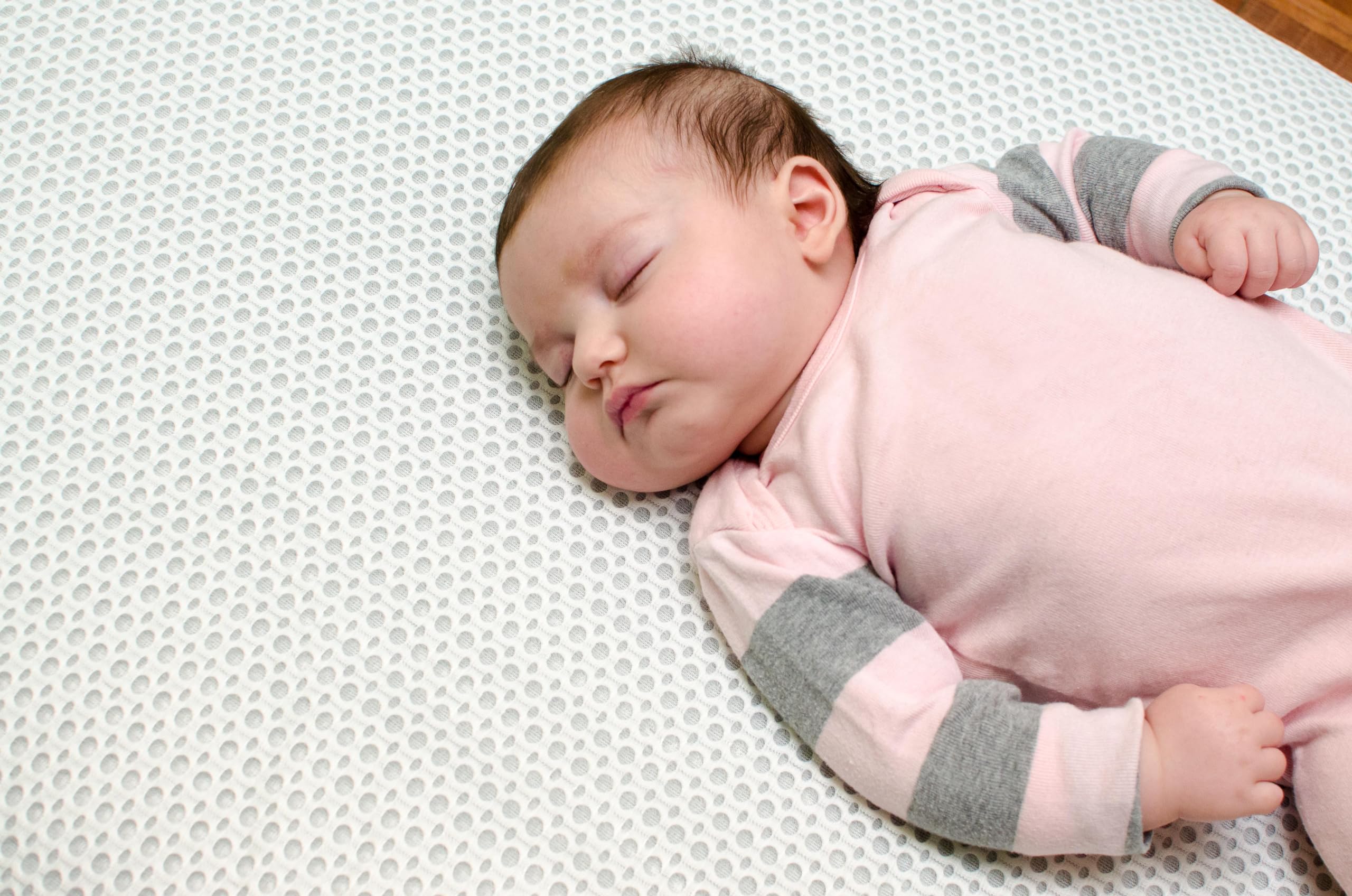 Lullaby Earth waterproof backing detail protecting crib mattress from spills