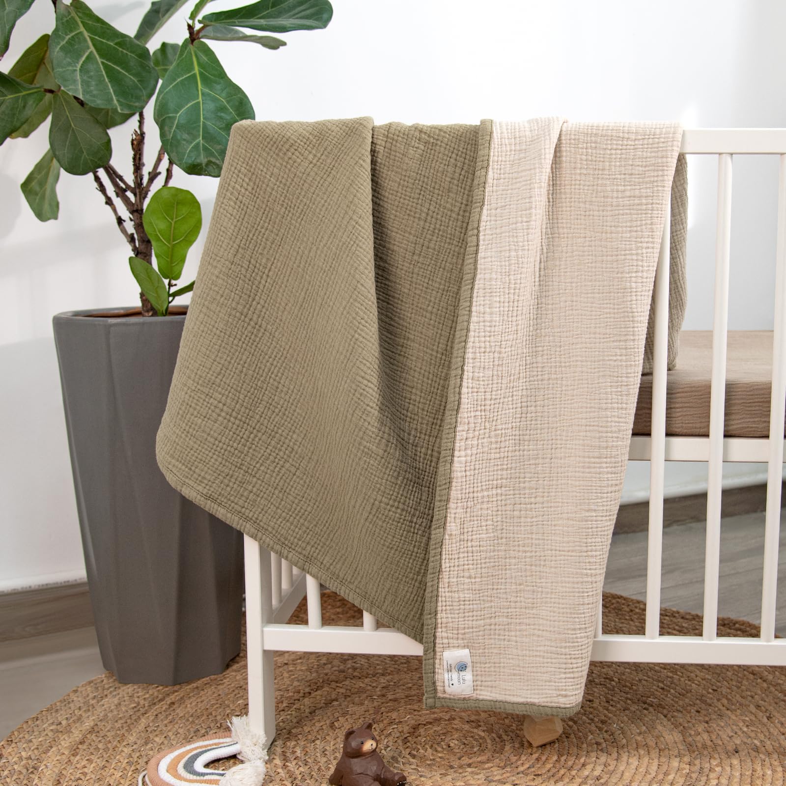 Lulu Moon Muslin Baby Blanket Olive on crib for soothing nap time