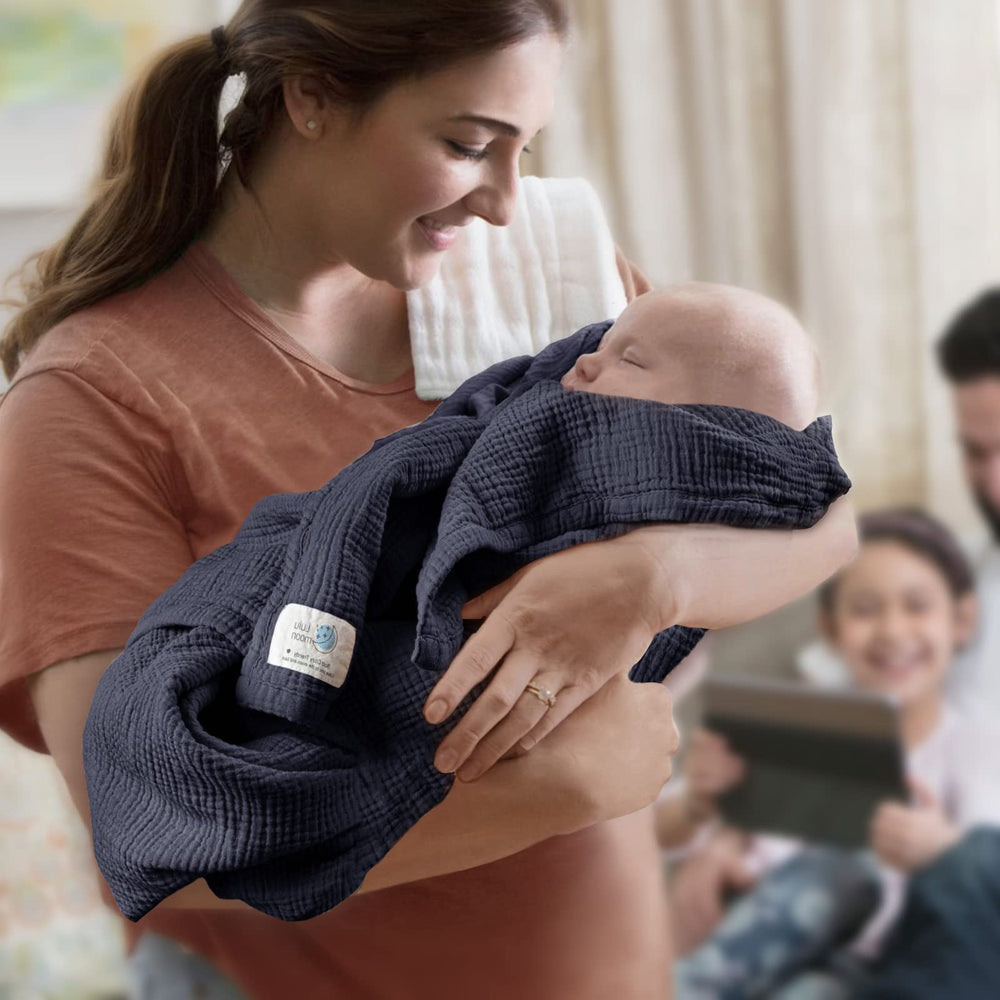 Lulu Moon muslin blanket blue on a beach day for sun-safe warmth