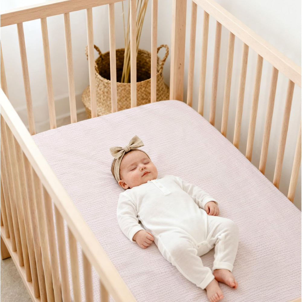 Lulu Moon Muslin Crib Sheets showing 9-inch deep pockets for mattress coverage