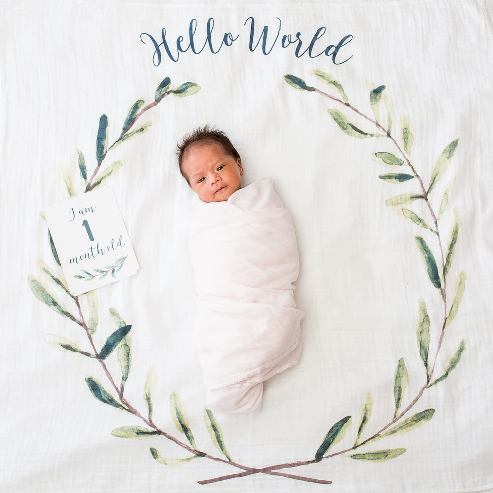 Lulujo blanket shown as swaddle or nursing cover for calm baby sessions