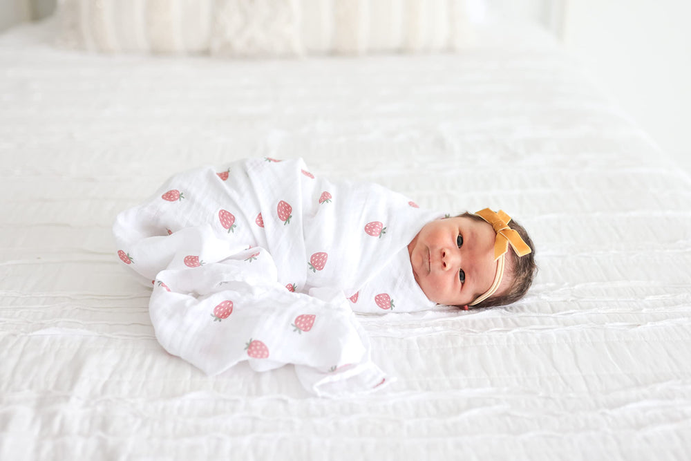 Lulujo swaddle blanket folded to show 40x40 inch size.