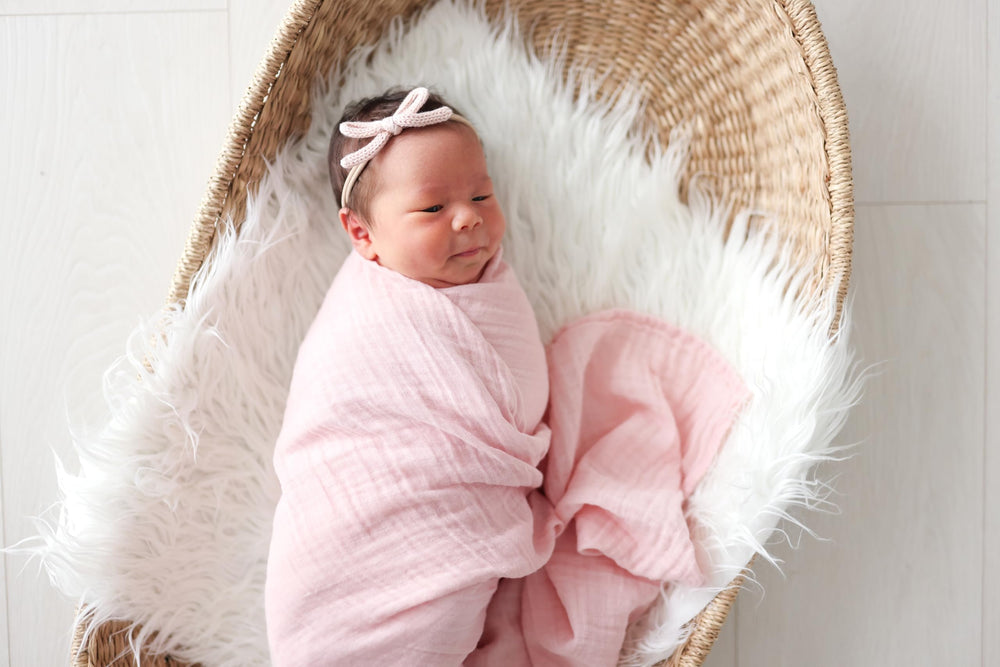 Lulujo swaddle blanket used as nursing cover with light muslin fabric.
