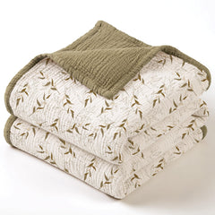 Lulumoon muslin blanket with brown branches folded for cozy home use