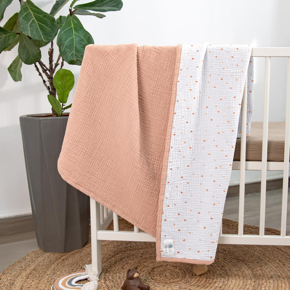 Lulumoon muslin blanket in nursery-use setup beside a crib.